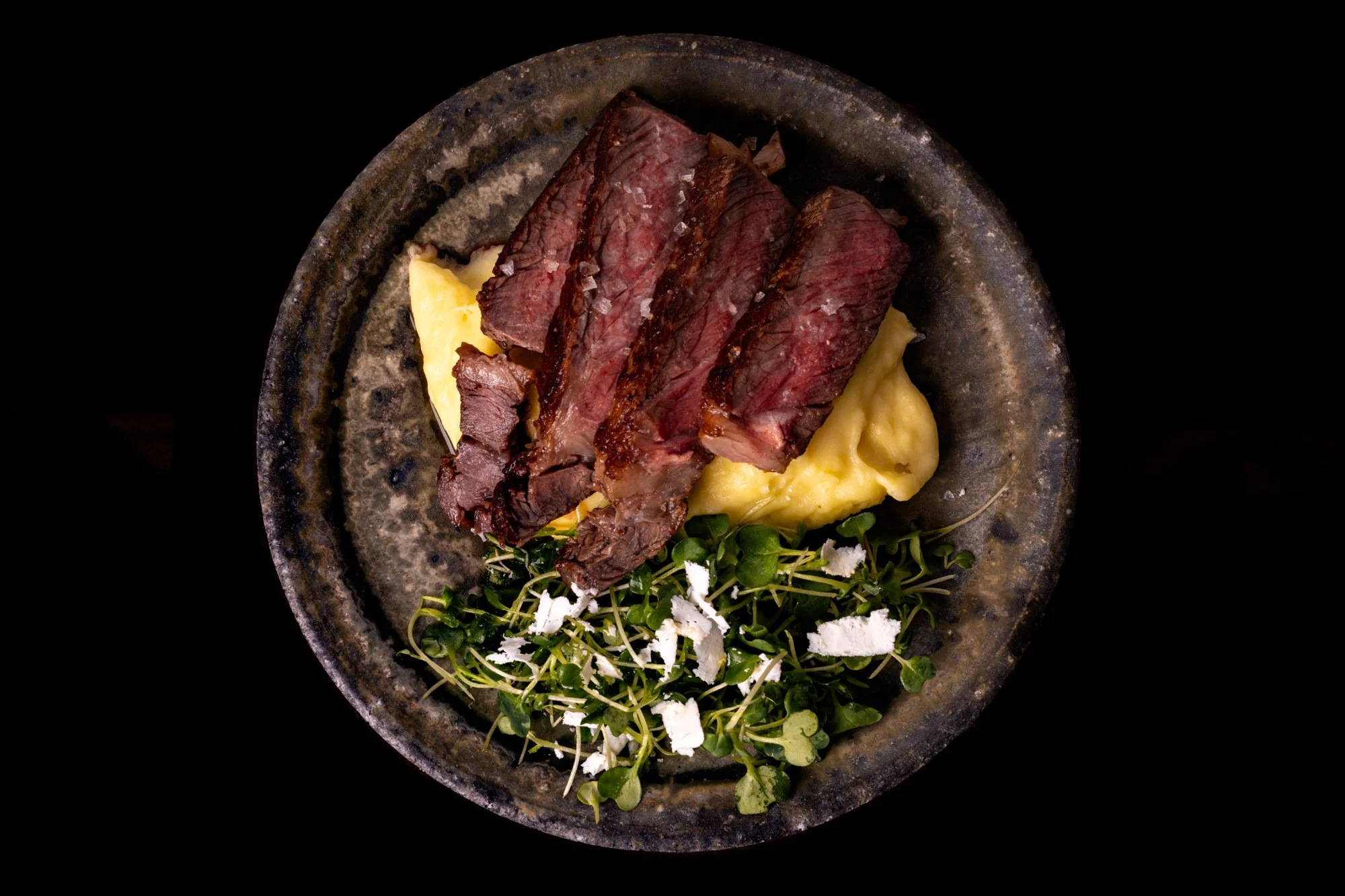24hr dry-brined ribeye with porcini, green peppercorn and cognac compound butter, bay whipped potatoes and horseradish micro greens with ricotta salata