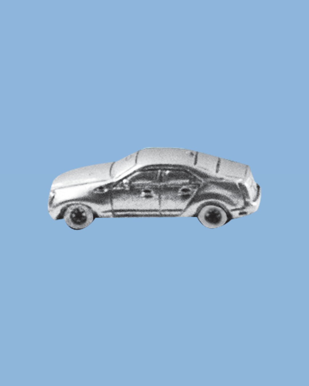 A silver toy car on a blue background
