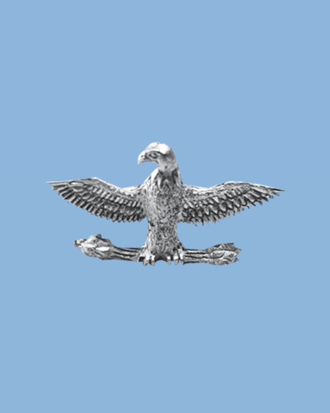 A metallic sculpture of a bald eagle with outstretched wings, perched on a branch, set against a light blue background.