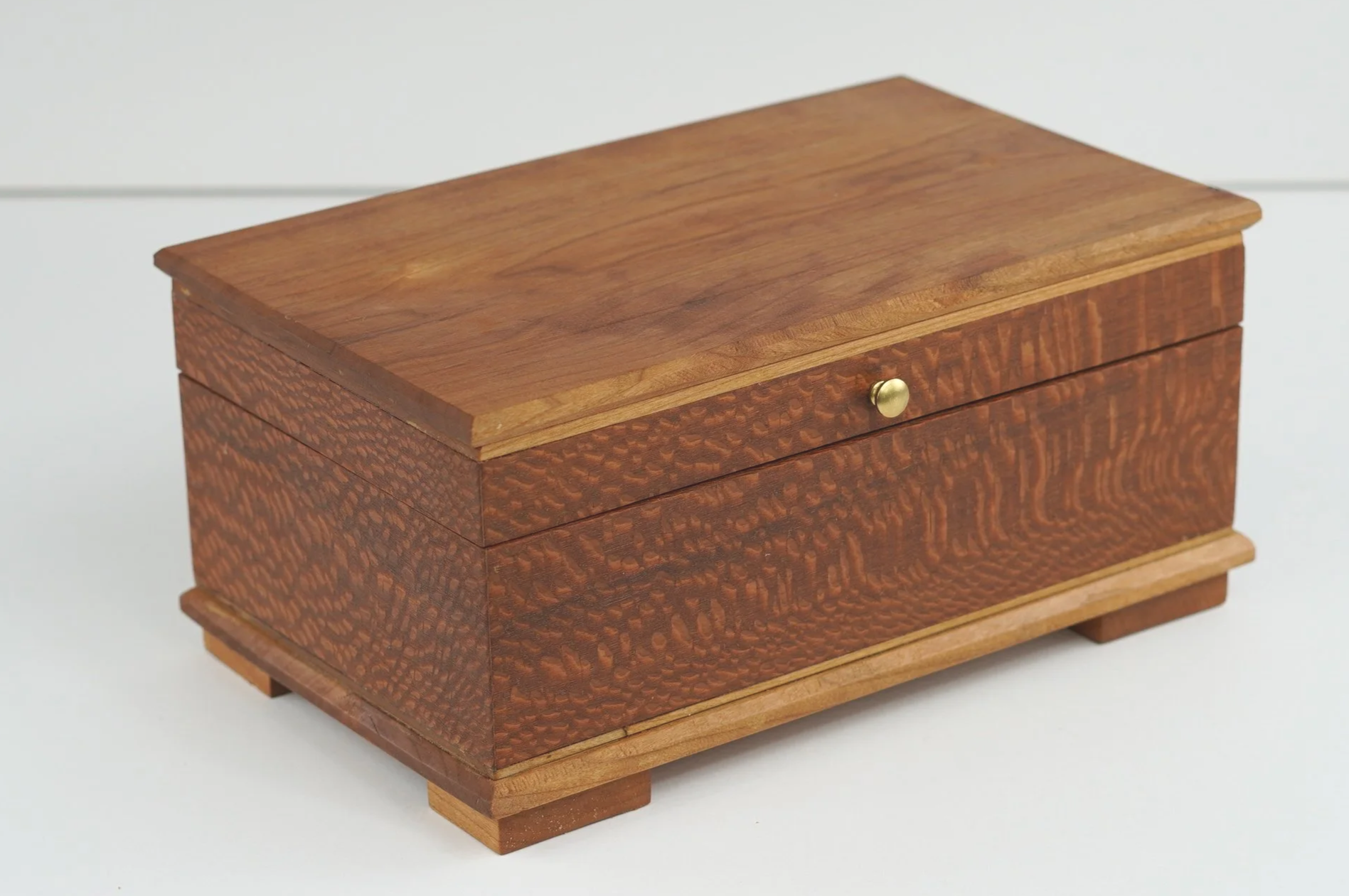 Leopardwood and Cherry personal keepsake box with sculpted form and storage compartment built into the lid.