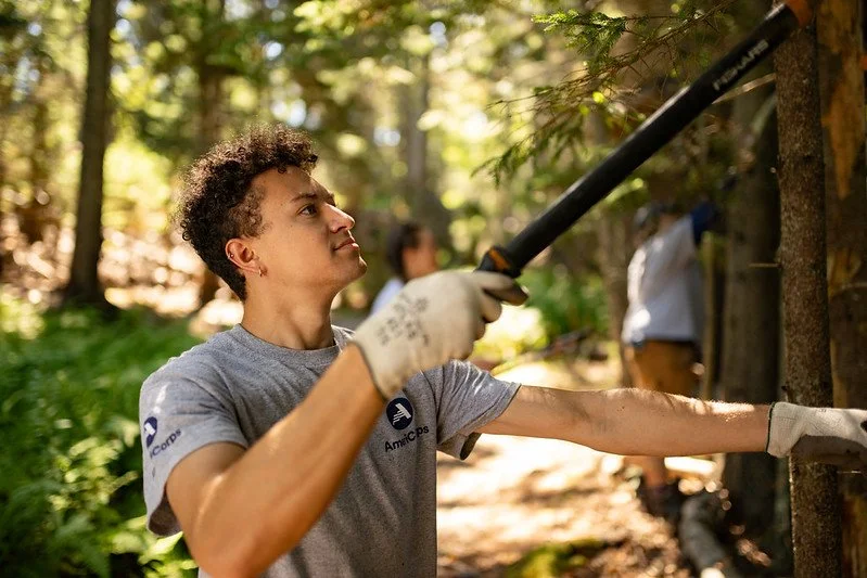 Clearing open spaces for trails on Jewell Island during a Day of Service with the Maine Island Trail Association.