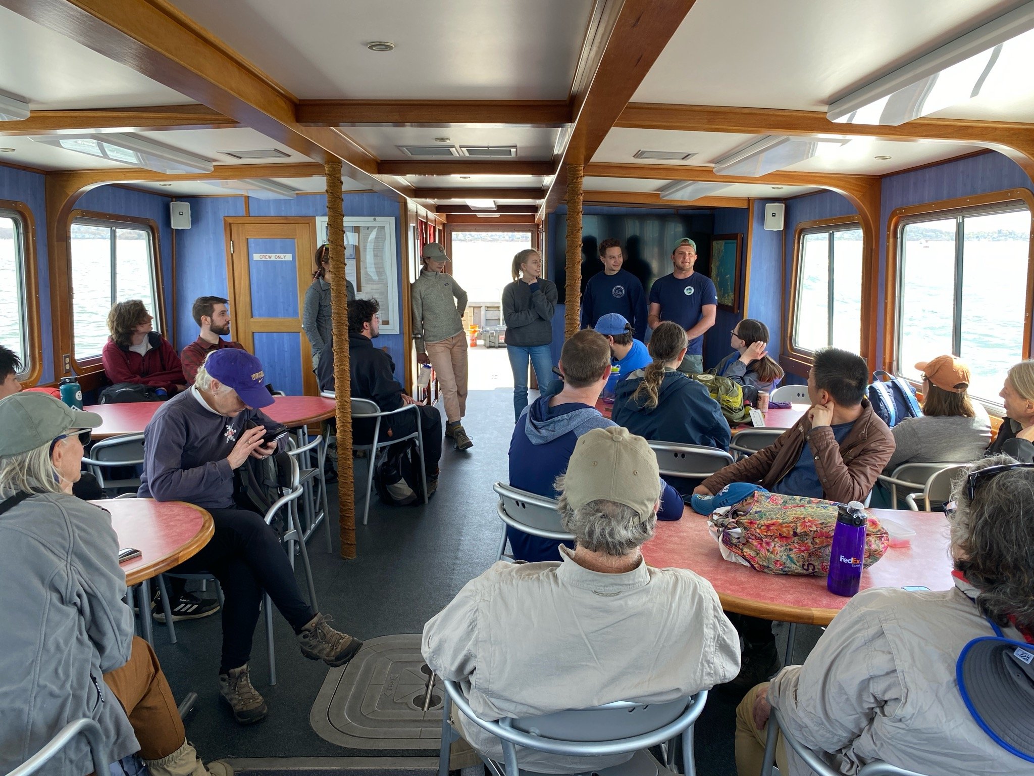 Sharing project updates en route to Grape Island for a volunteer invasive species removal day.