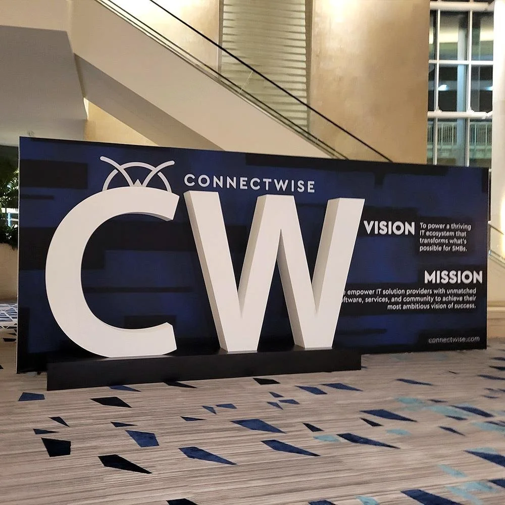 ConnectWise sign with large letters 'C W' and the company’s vision and mission statements.