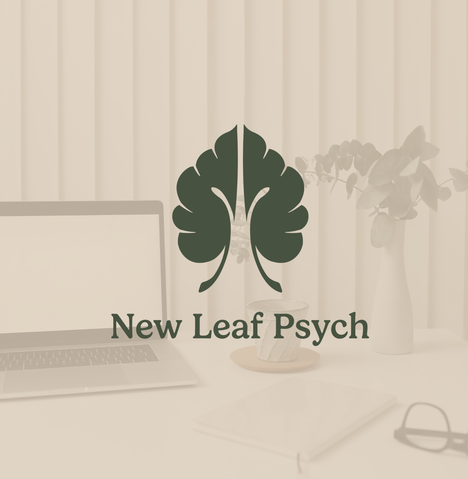 Interior scene with a computer, a plant in a vase, and a sign that reads "New Leaf Psych" against vertical blinds.