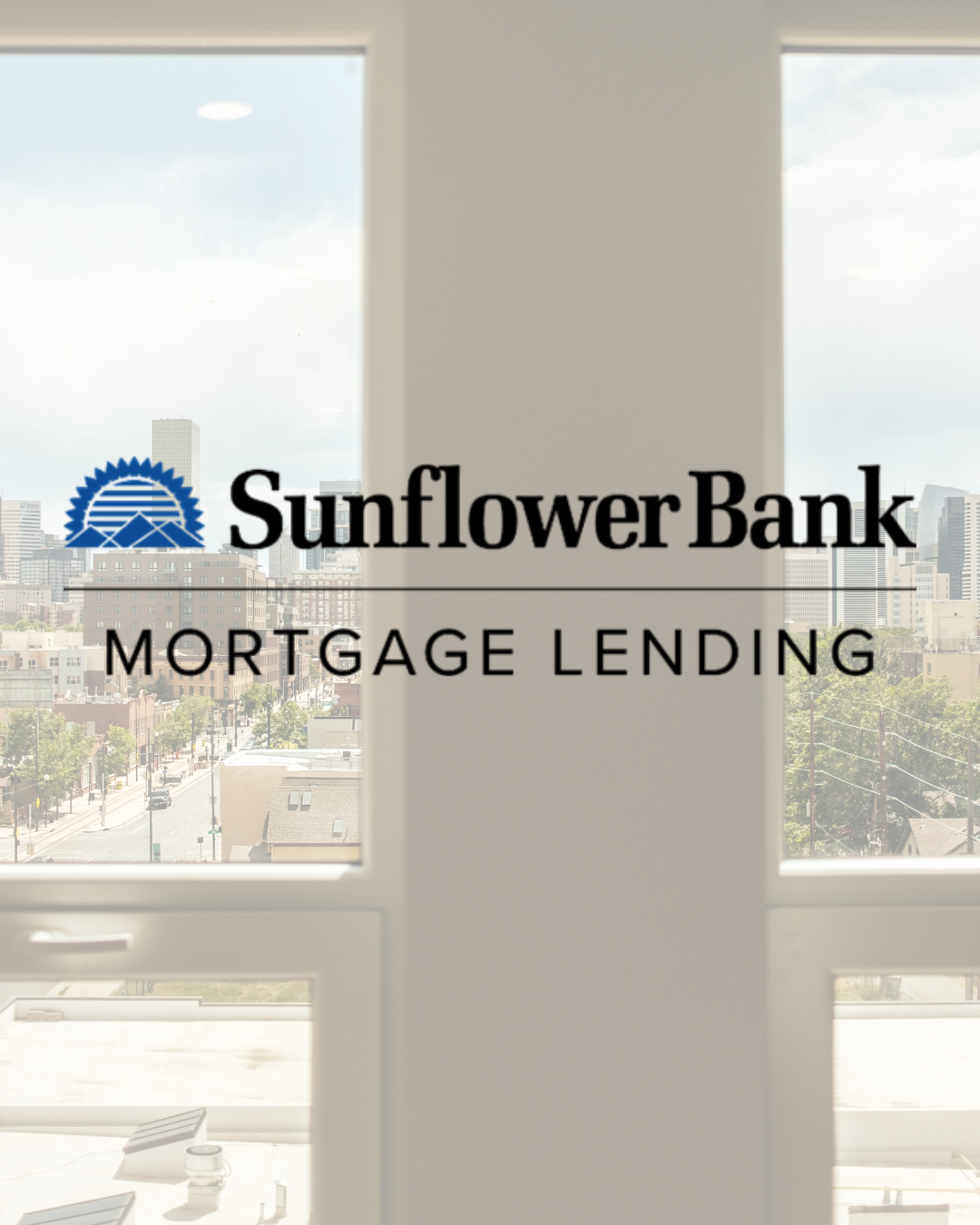 Sign for Sunflower Bank mortgage lending viewed through a window with a cityscape in the background.