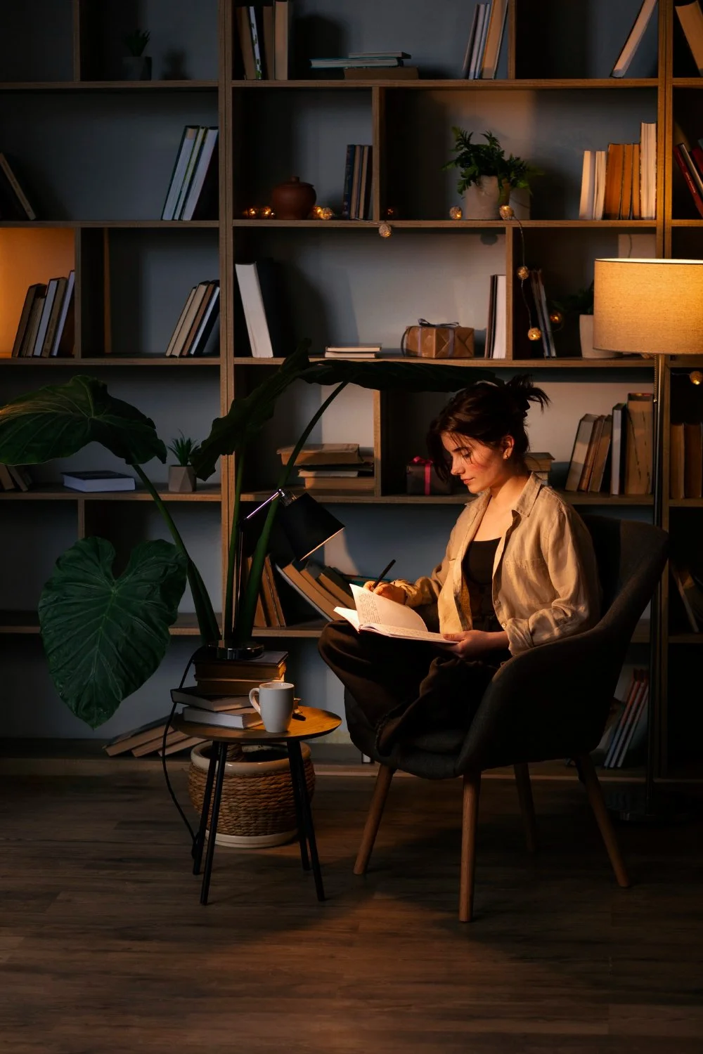 A person reading quietly at night in a reflective space, representing focus, inner clarity, and contemplation.