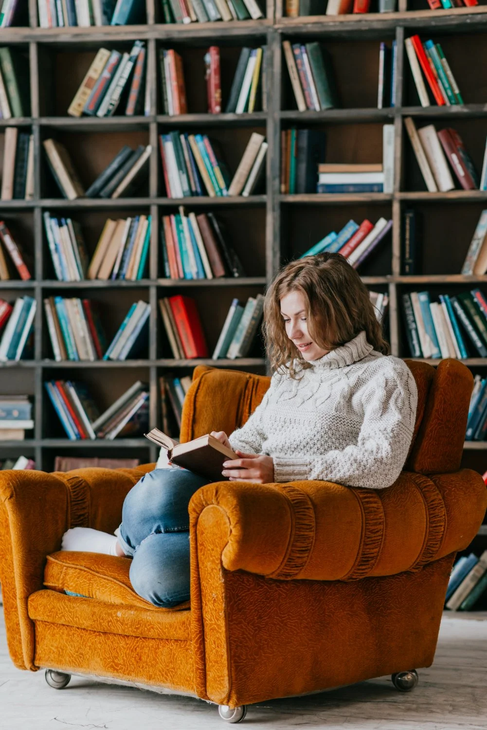 A person reading in a personal study space, representing reflection, curiosity, and insight.