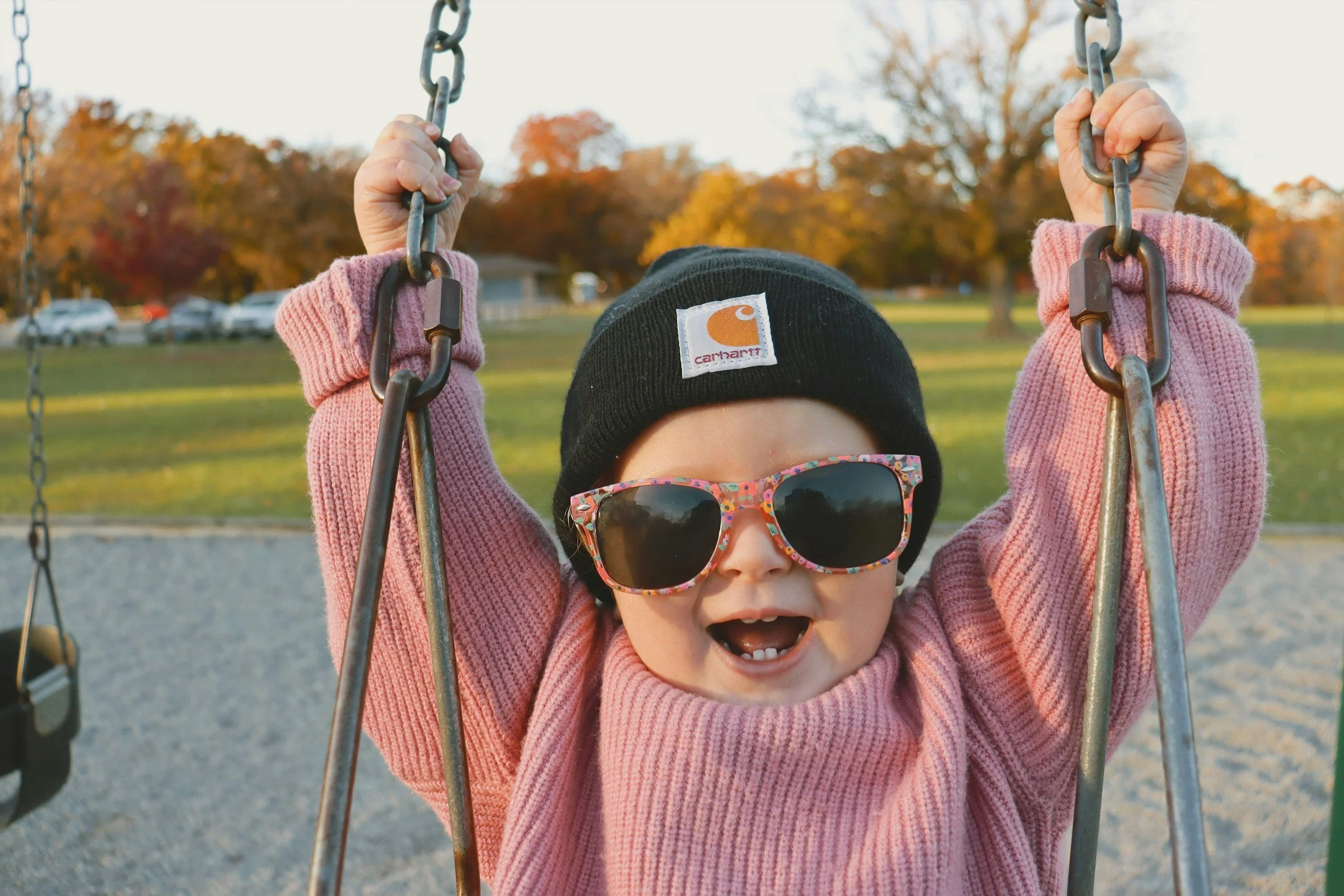 A happy toddler on a swing