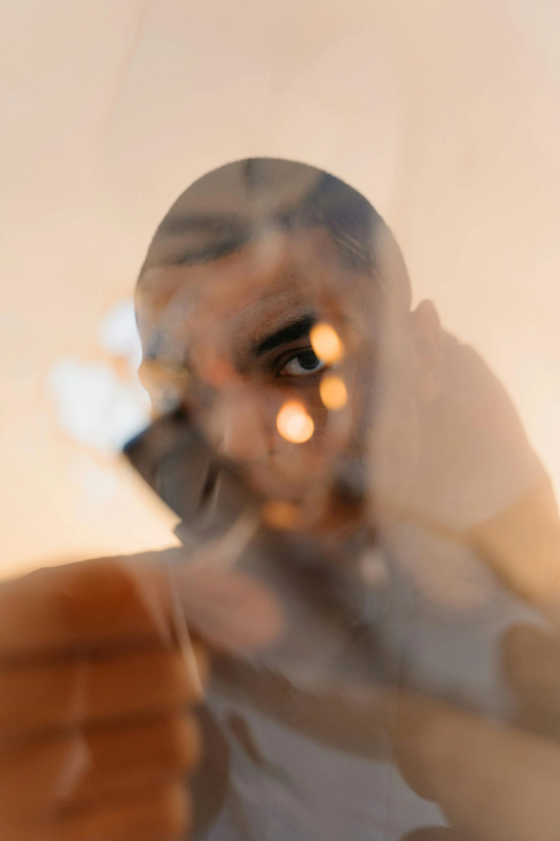 Black and white photograph of a woman with long hair, pearl earrings, and a prominent nose, looking to the side with her eyes closed.
