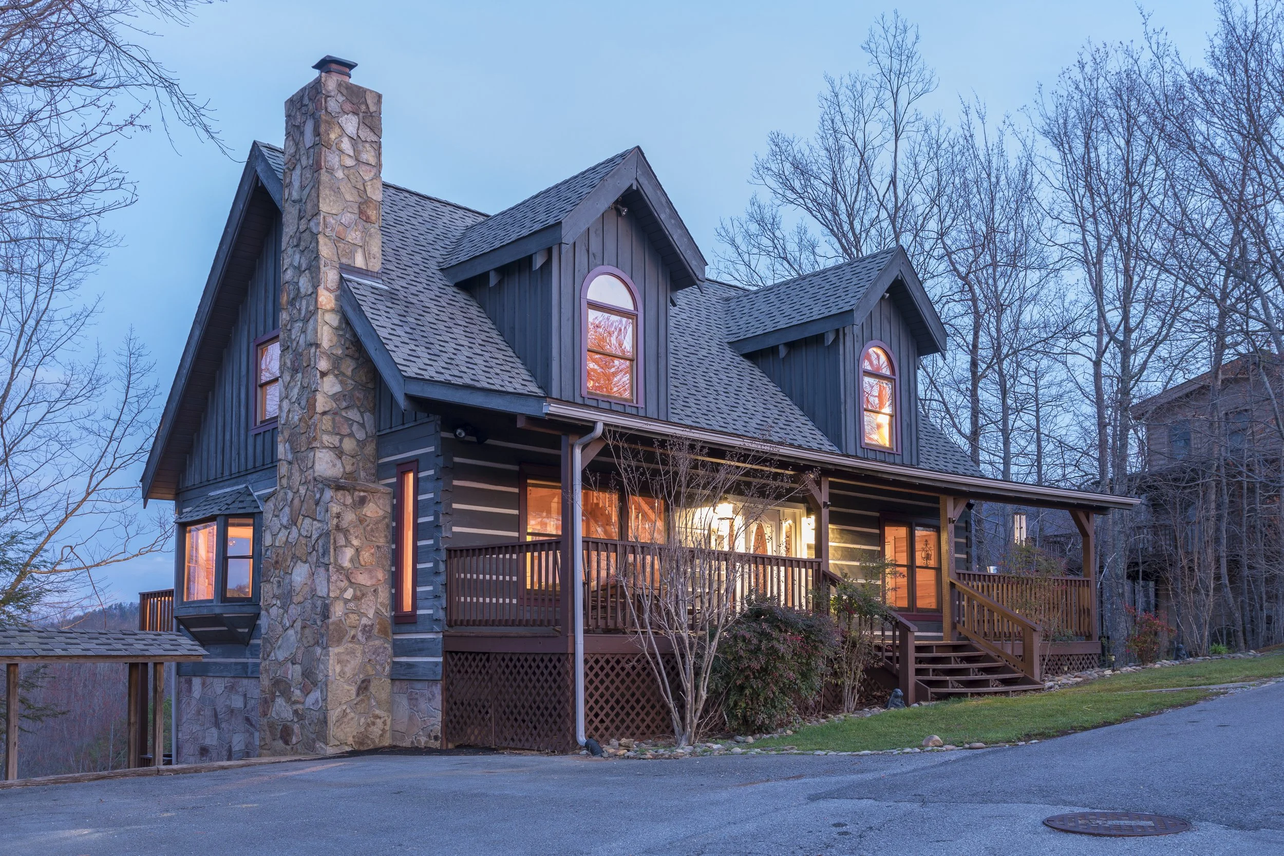 Real estate photo gallery of a rental cabin in gatlinburg, TN featuring exterior twilight images and interior photos.