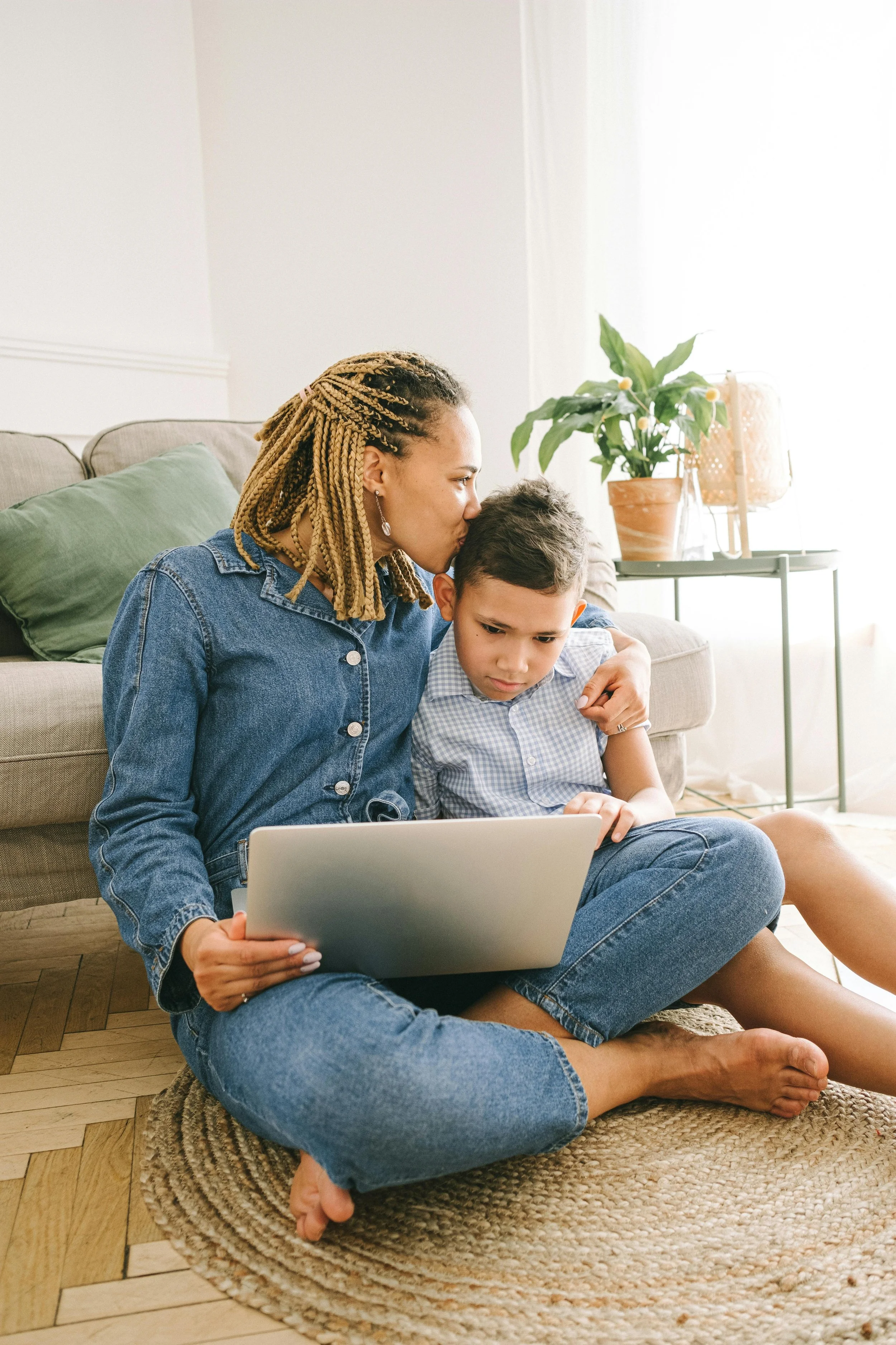 Mother and child sitting at laptop.