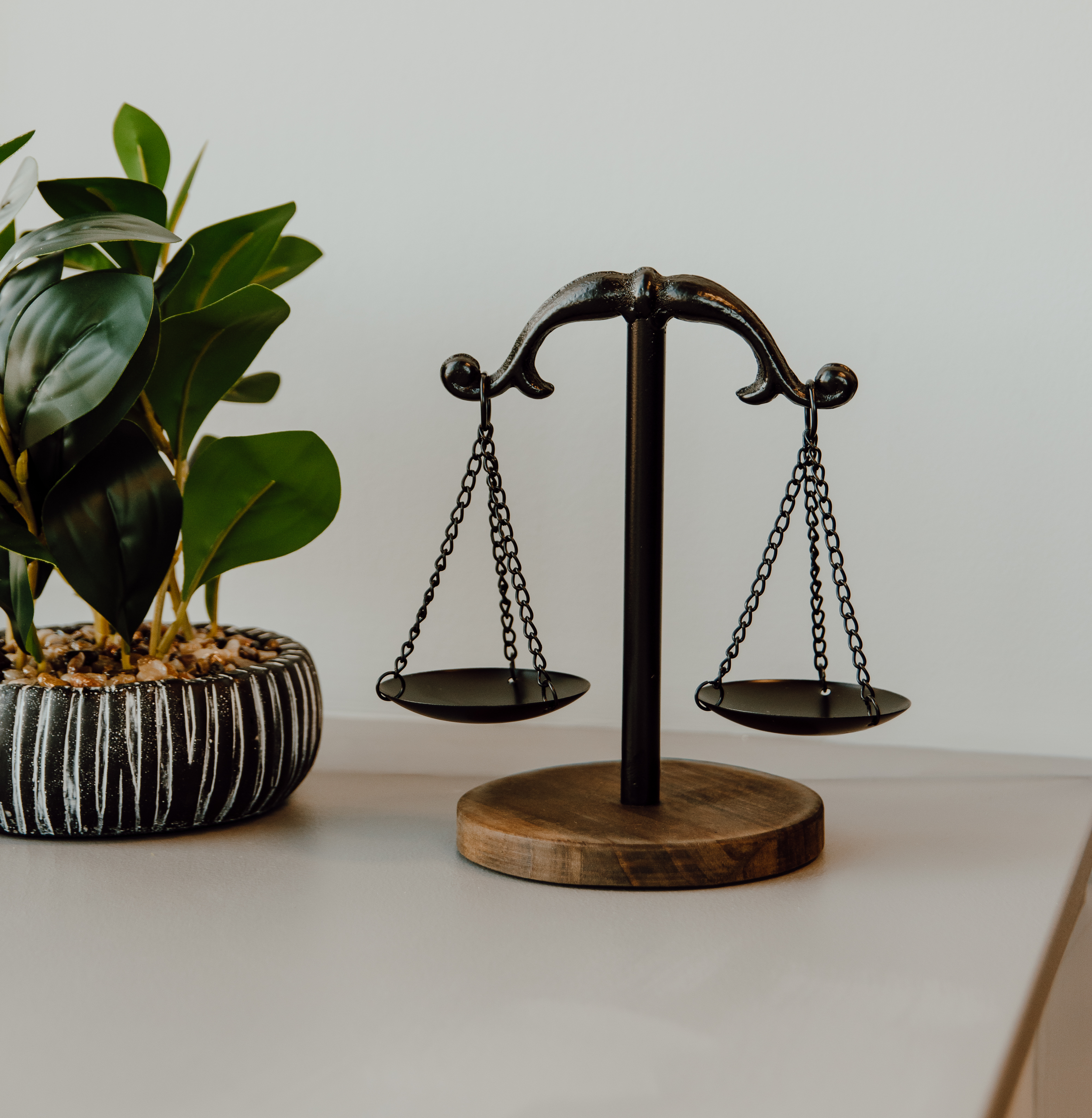 Legal balance scale beside potted plant symbolizing integrity and stability in a Jackson, Michigan law office
