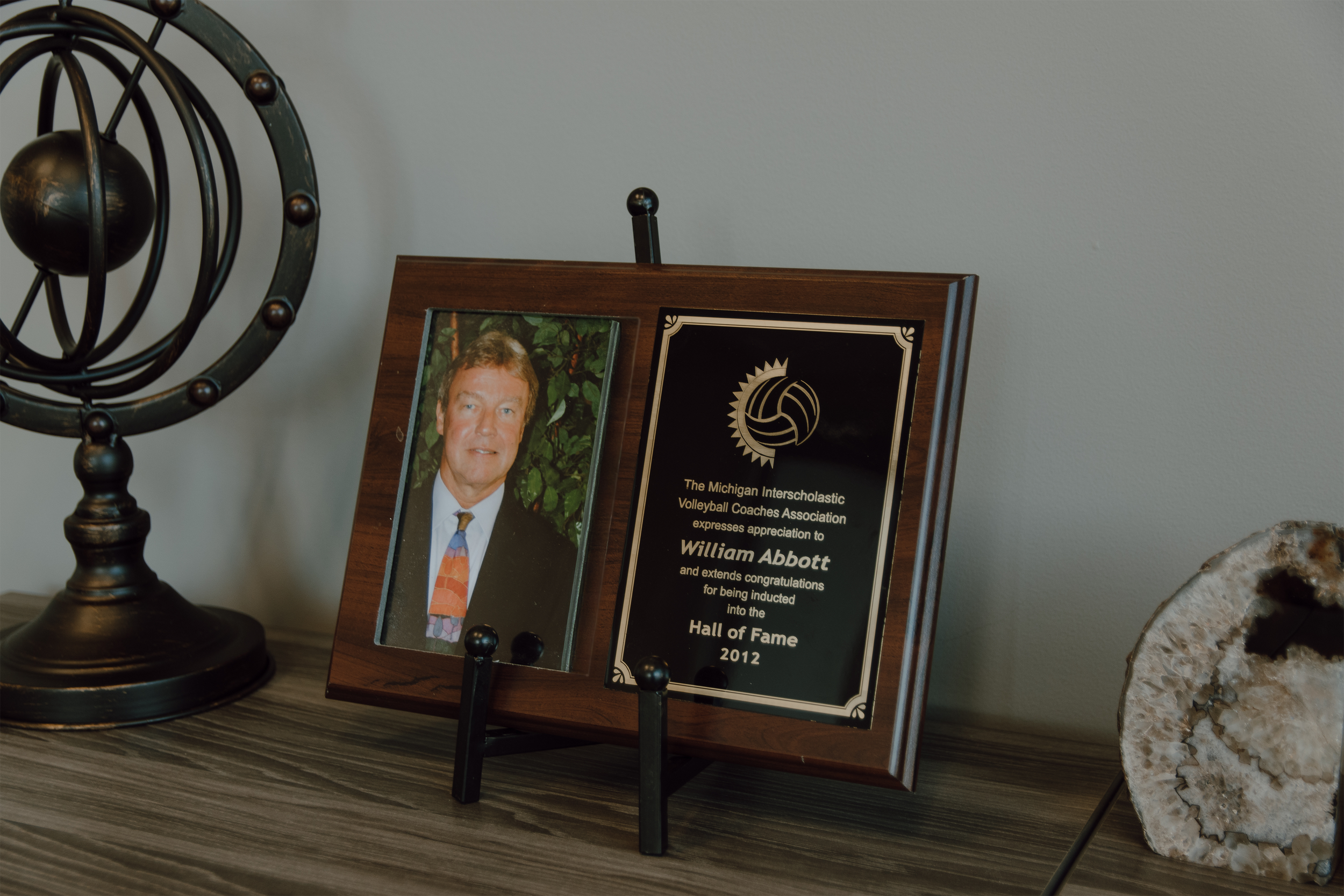 Framed legal award and professional portrait reflecting experience and peer recognition at a Jackson law firm
