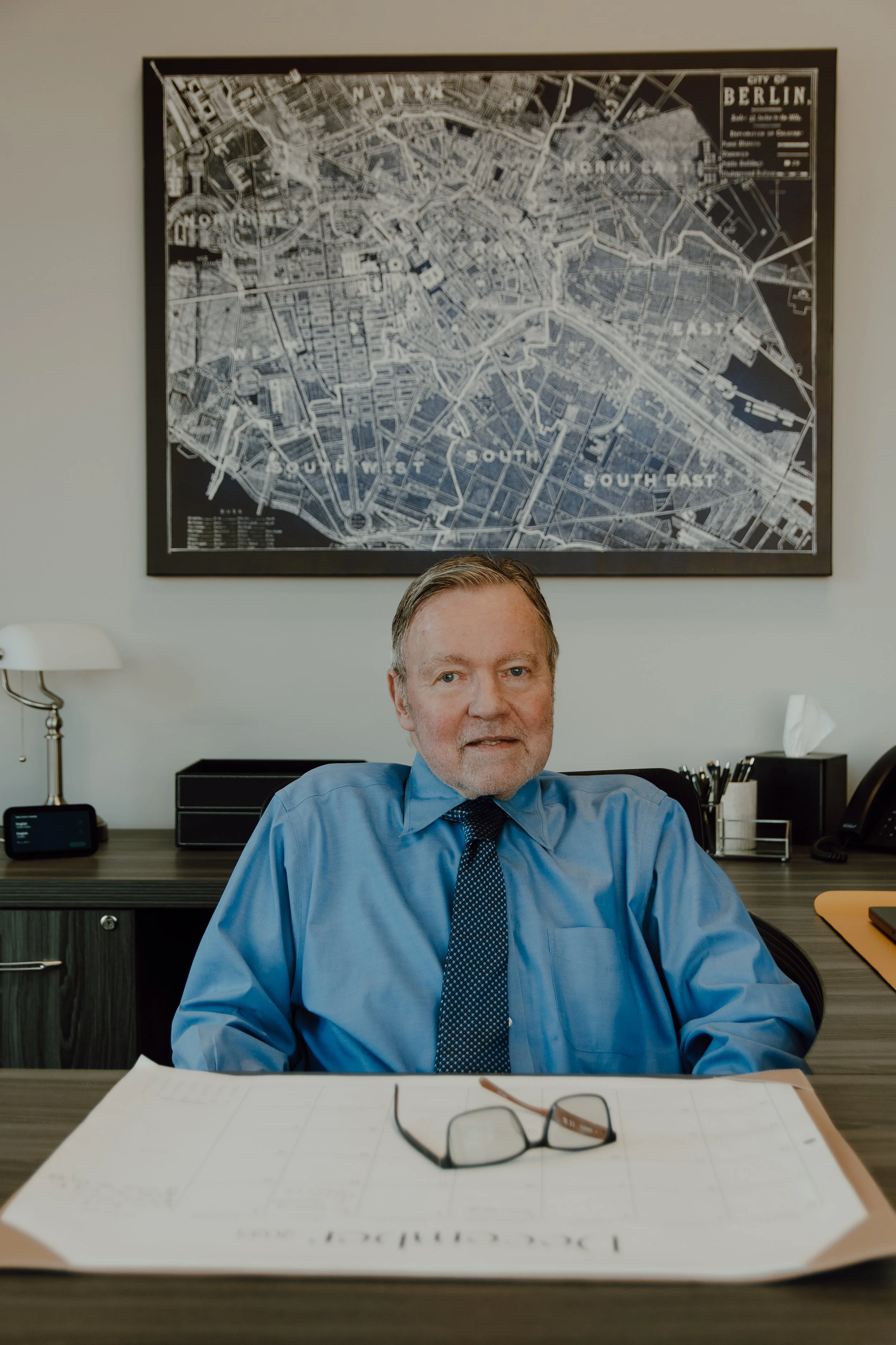 William M. Abbott, Jackson, Michigan attorney, seated at his office desk with legal documents and maps behind him