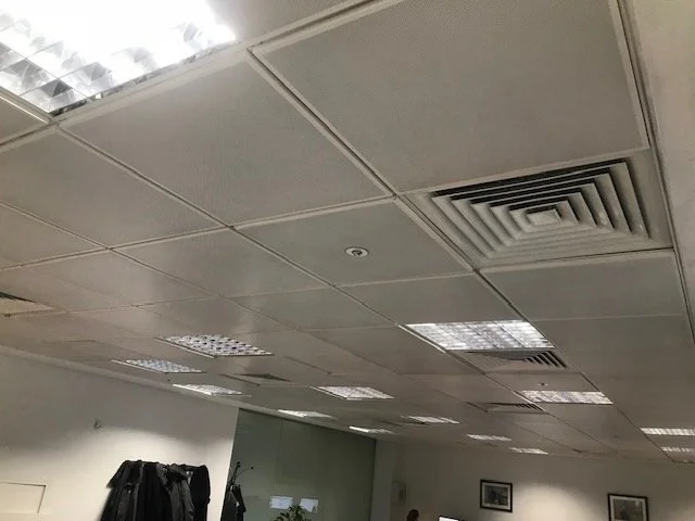 Professional ceiling cleaning service removing dust and dirt in commercial workspace