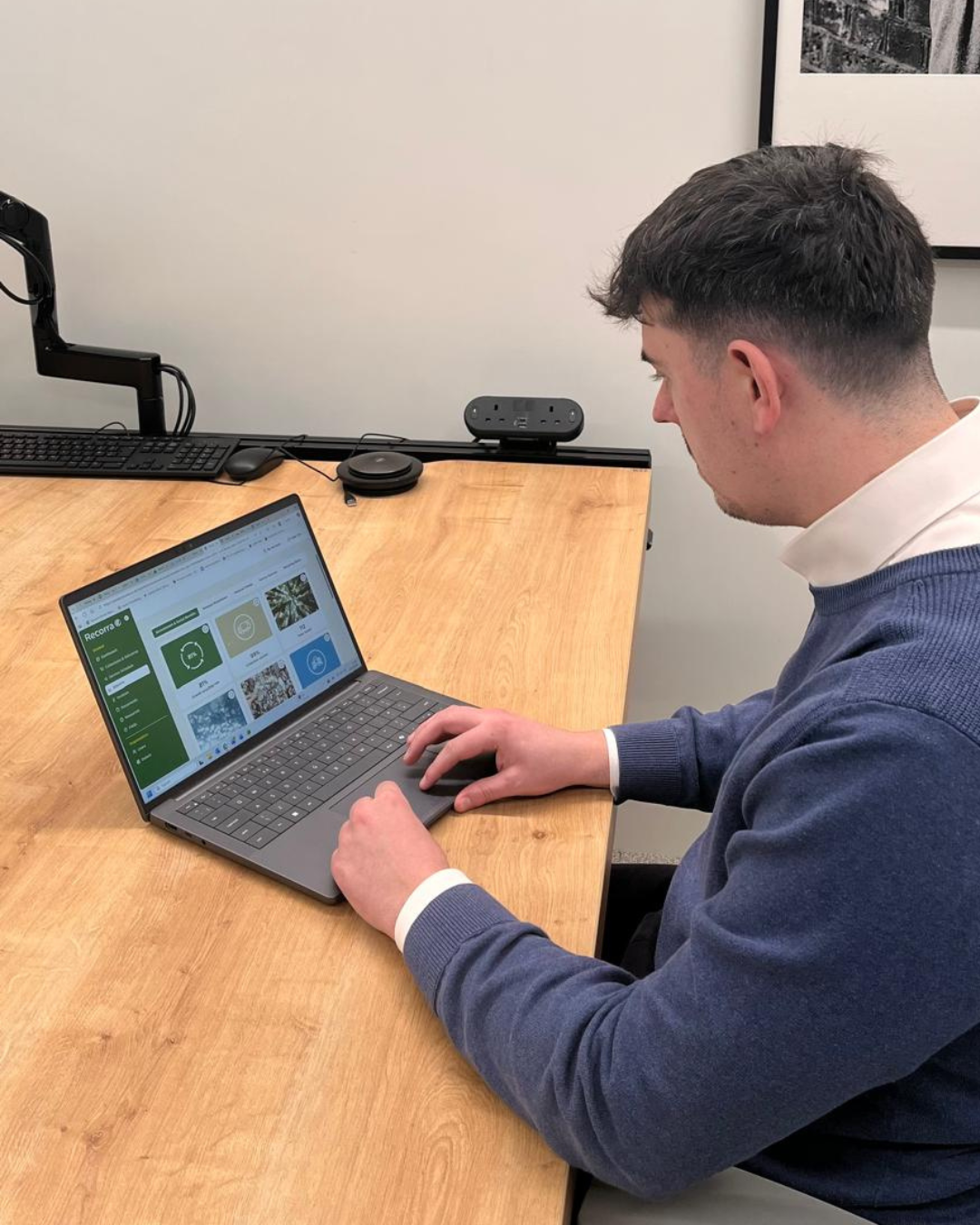 Cleaner using environmentally friendly cleaning products in a modern office workspace