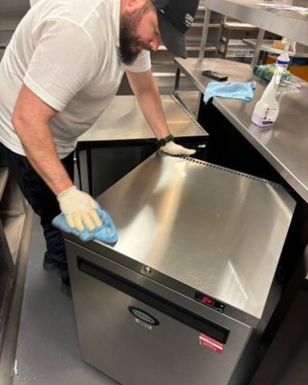 Professional kitchen deep cleaning service sanitising surfaces and equipment in commercial kitchen