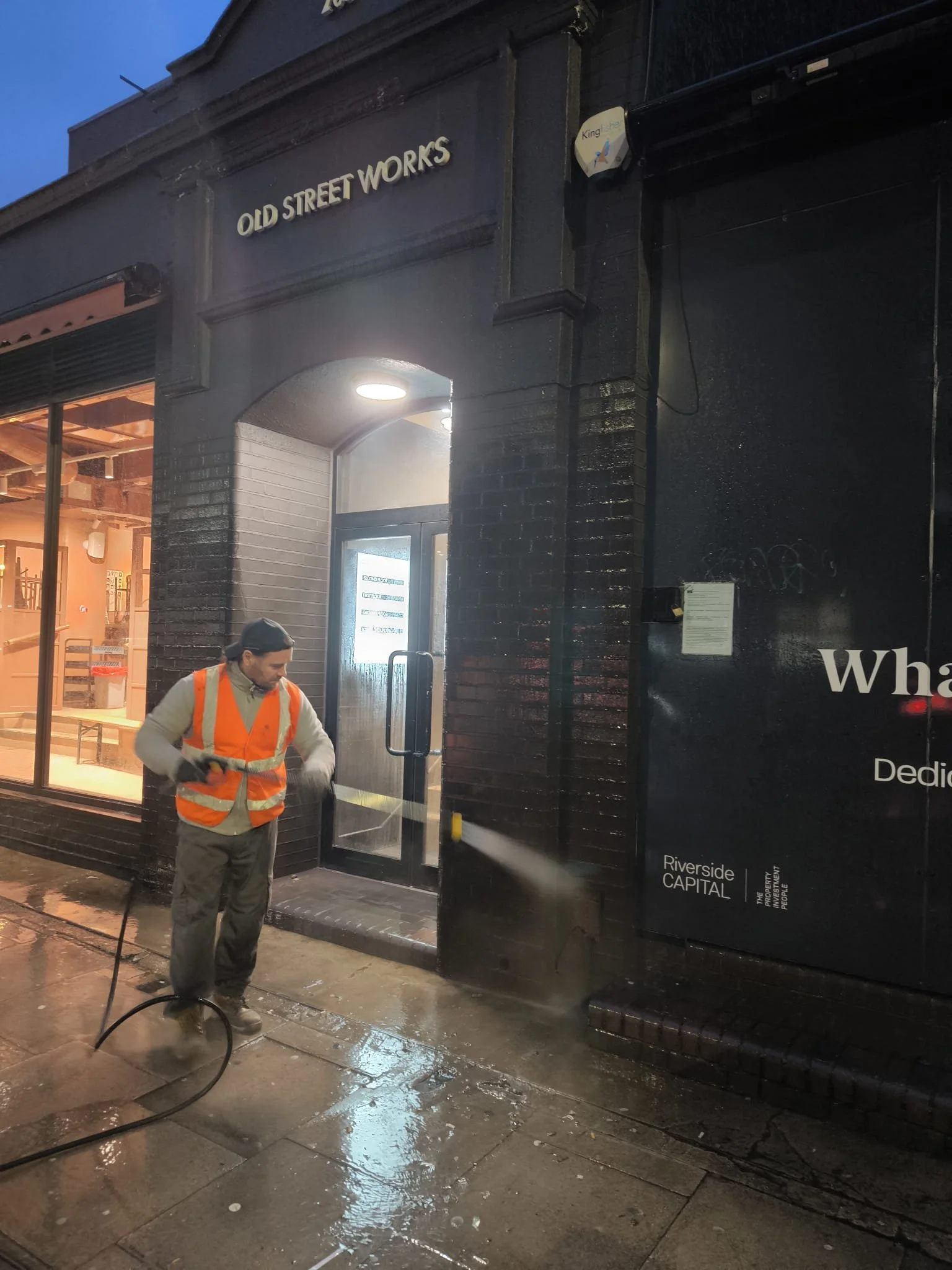High-pressure jet washing removing dirt and grime from exterior commercial surfaces