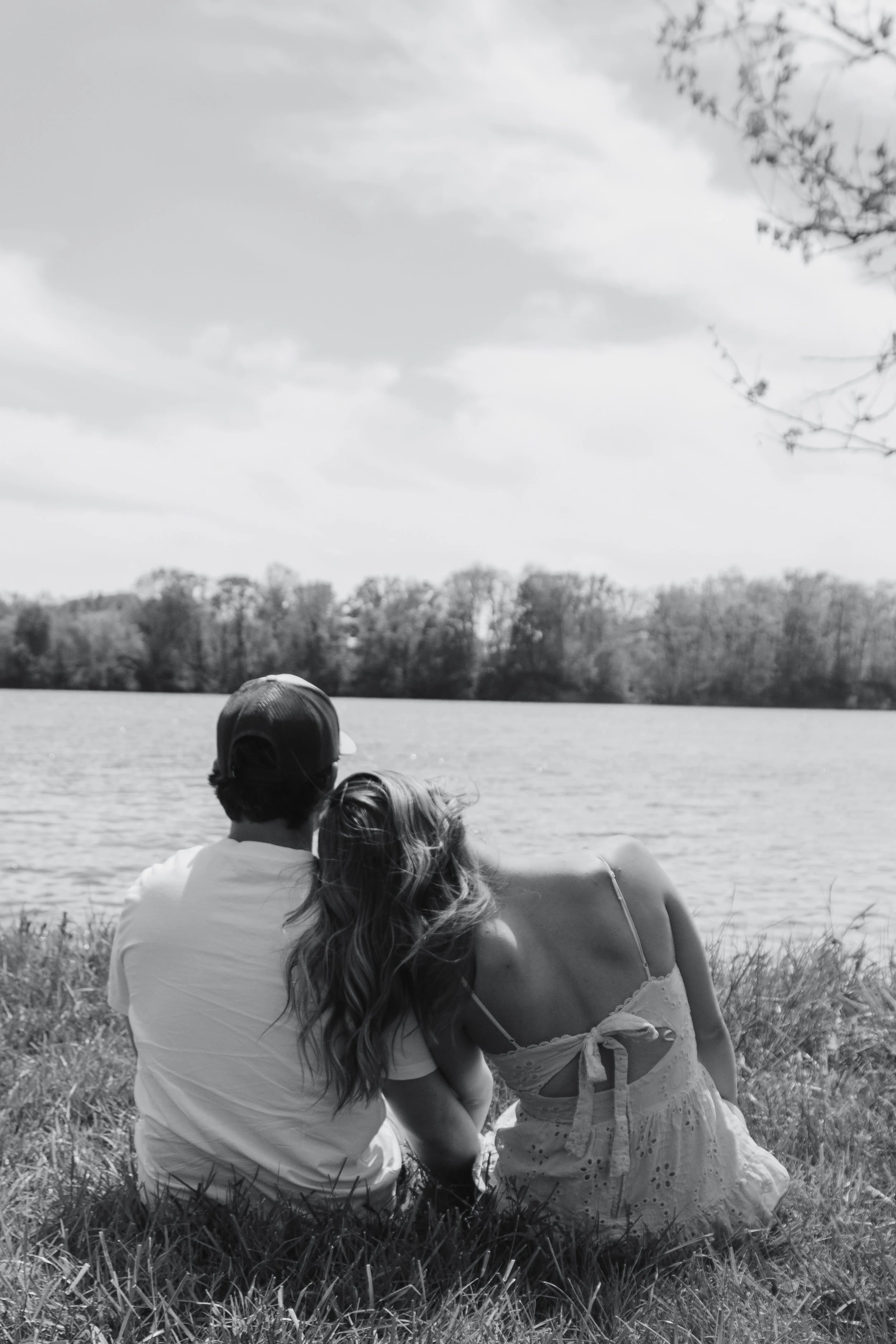 Laurie’s customers, Mariana and Carmen holding hands on a green lawn on their wedding day.