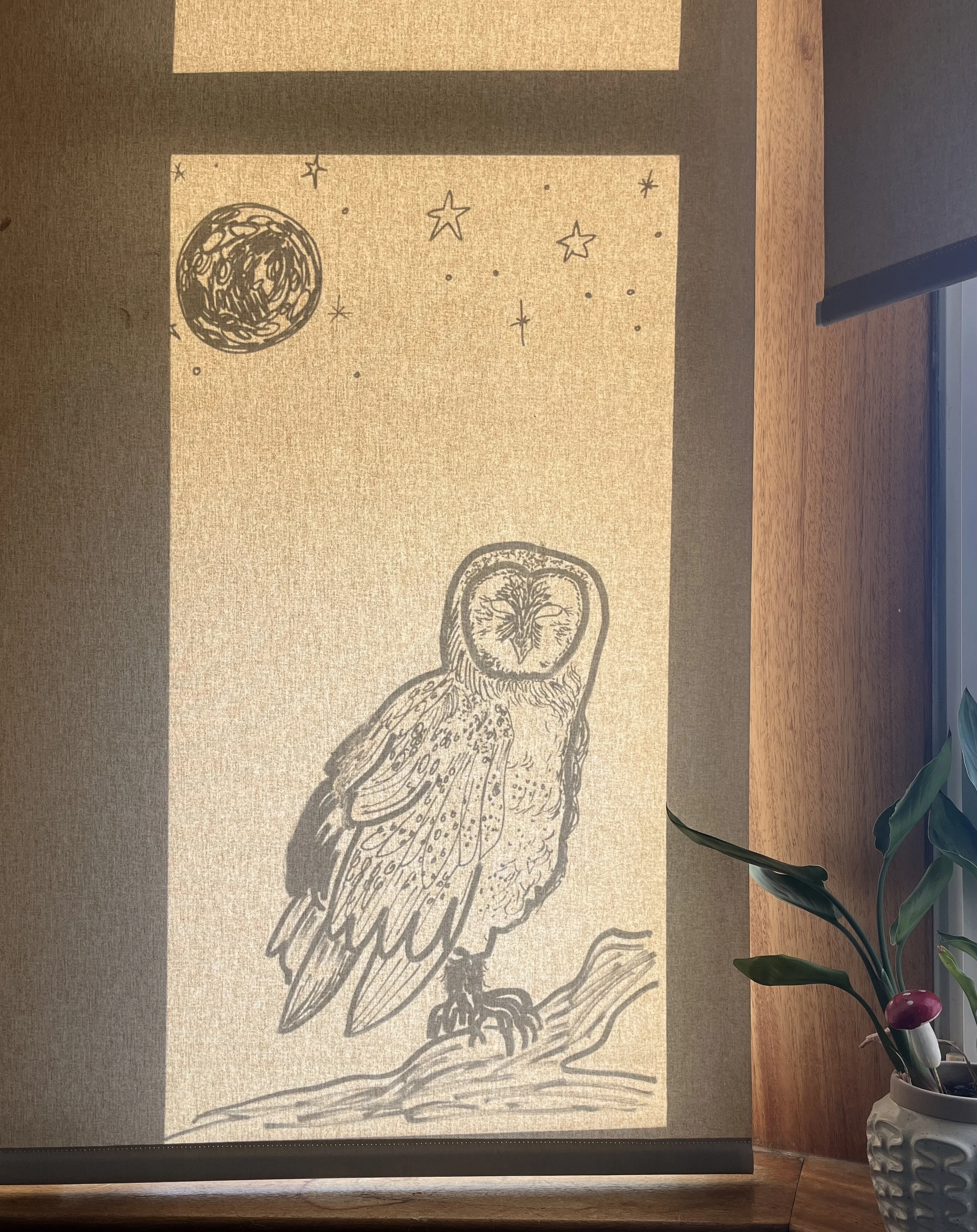 Artwork of an owl on a branch, with a moon and stars in the sky.