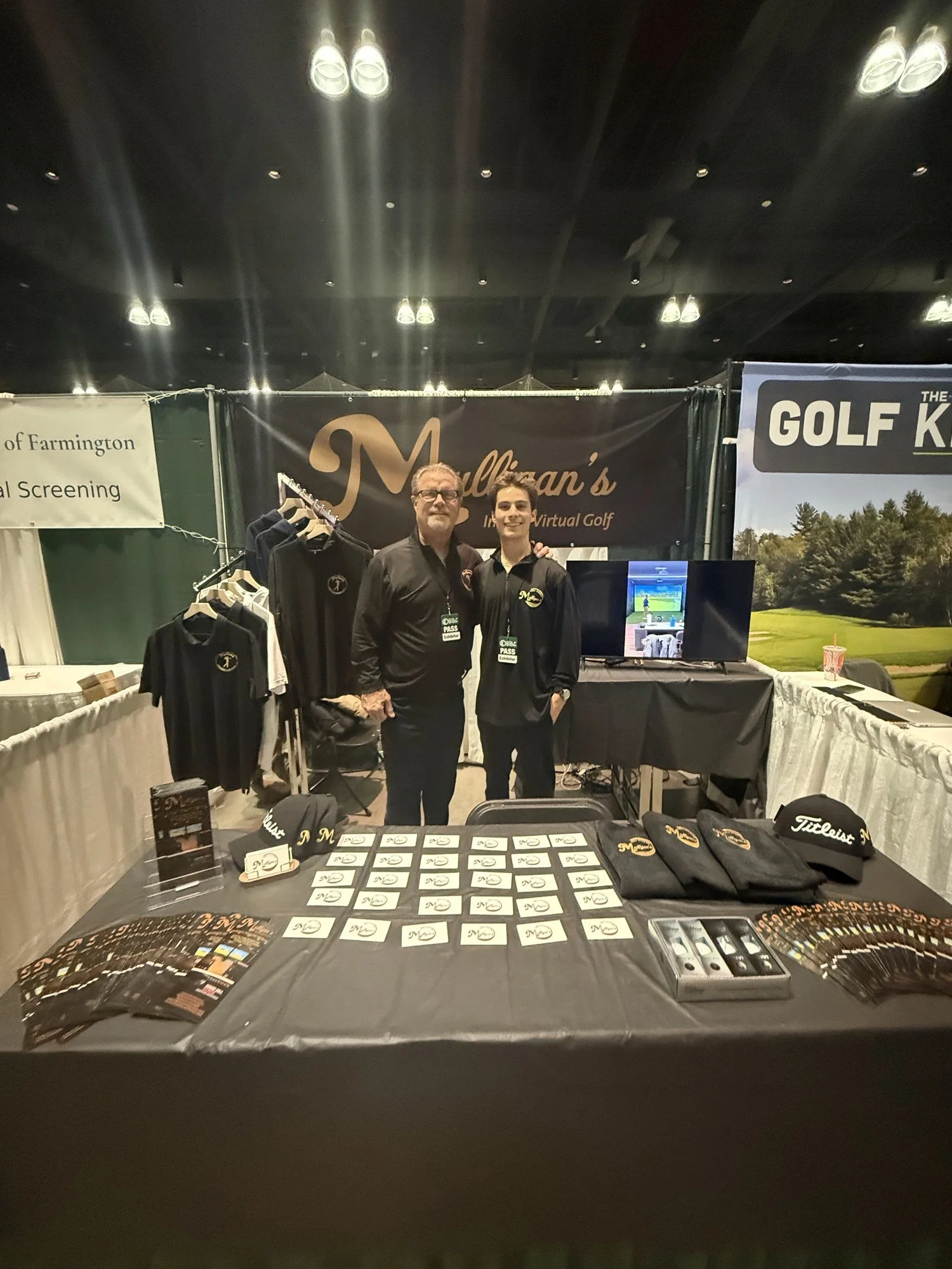 The father and son who run Mulligan's Virtual Golf, at their booth