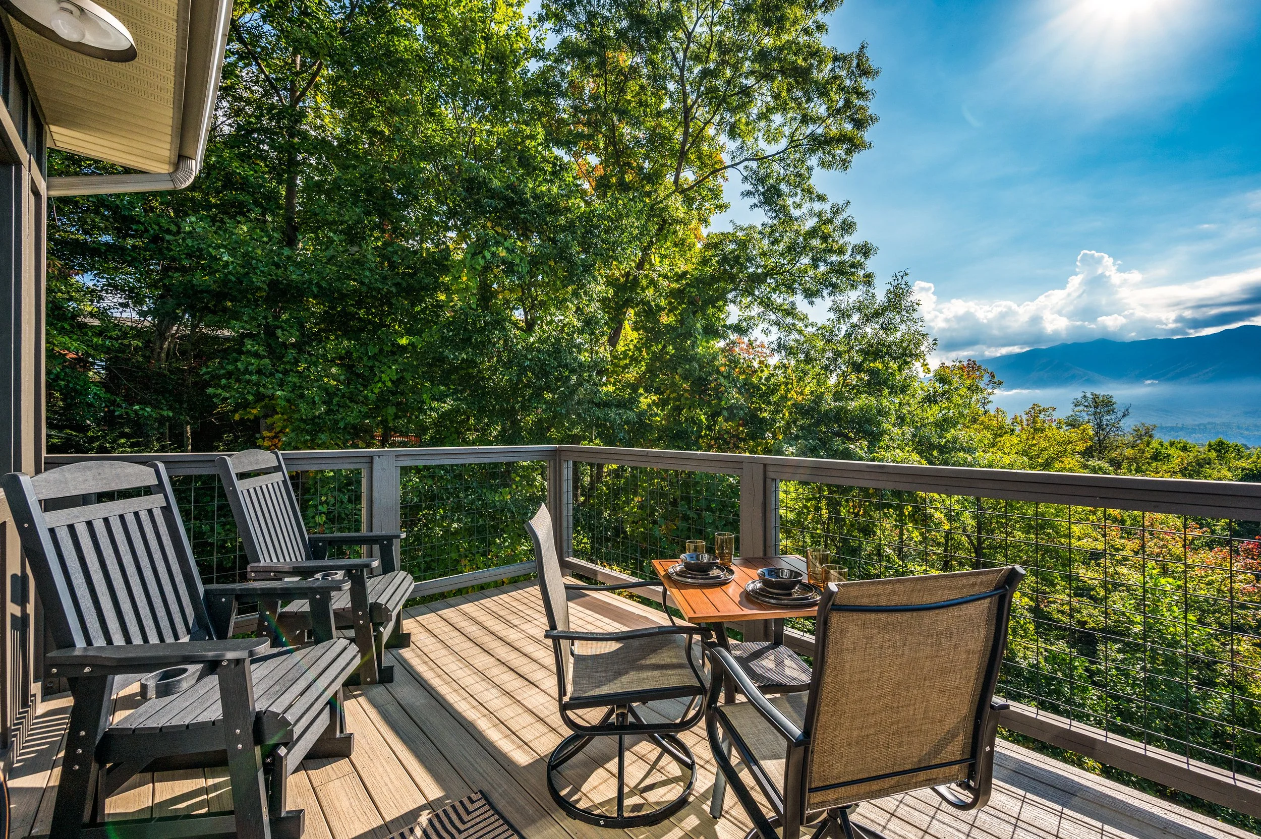Sip morning coffee or evening wine from this private terrace overlooking the treetops and distant peaks.