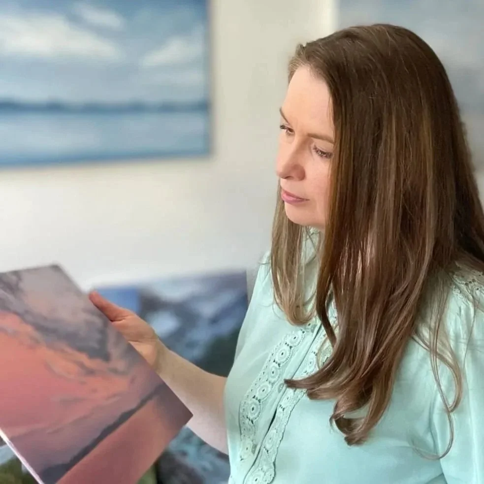 Traditional painter Marina Sosnovskaya in her studio with one of her artworks in hands.