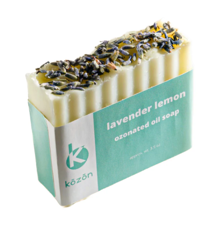Bar of lavender lemon ozonated oil soap with dried lavender on top, in teal and white packaging.