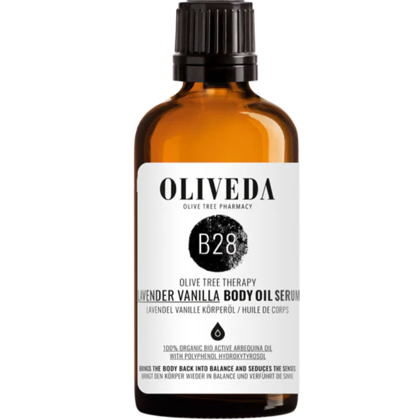Amber glass bottle of Lavendar Vanilla Body Oil Serum from Oliveda, featuring a white label with black text, and a black cap.