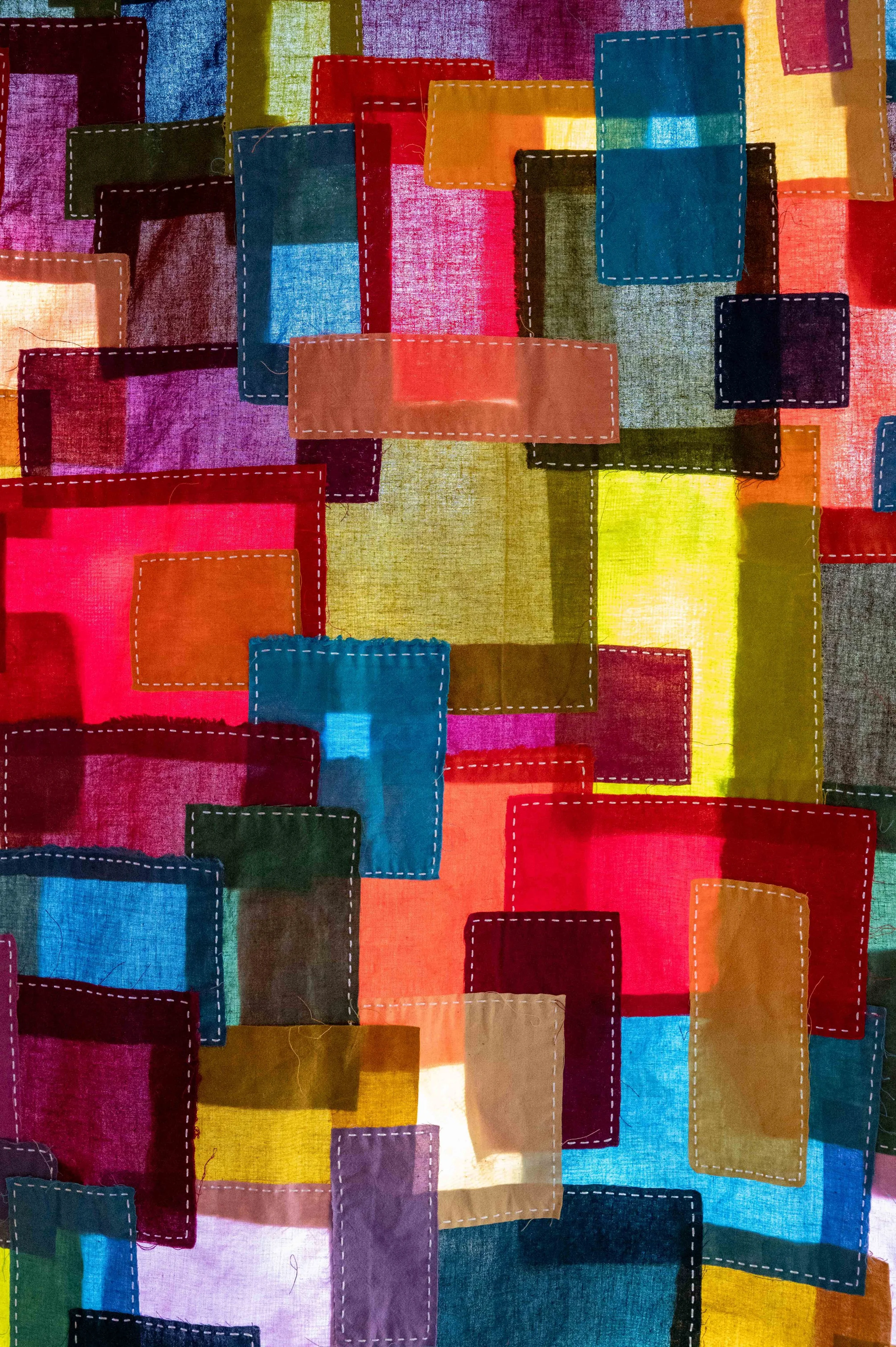 Lightbringer • 2026 • Cherrywood Hand Dyed Fabric cotton scraps and offcuts. Hand stitched in Boro style with moyouzashi style sashiko stitching.
• 80"x 28". 
• Available: Inquire for price
•Note: Close up of stitching and light