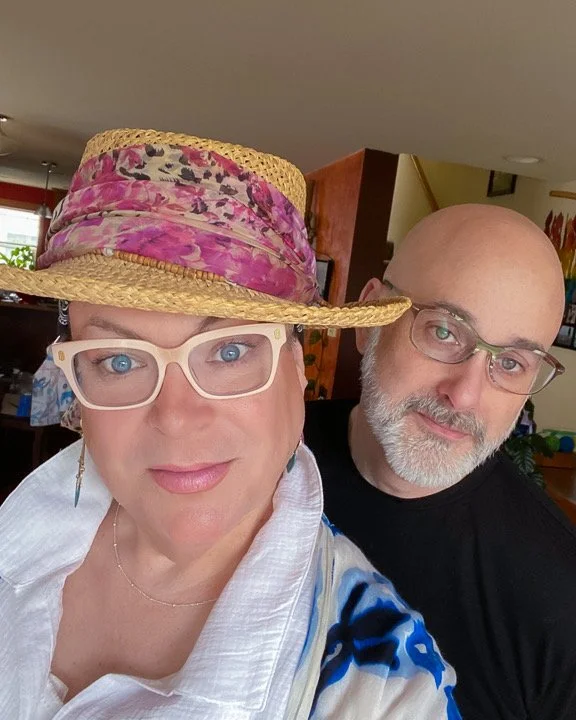 Photo of shannon wearing a hat with a pink scarf and jason standing behind her