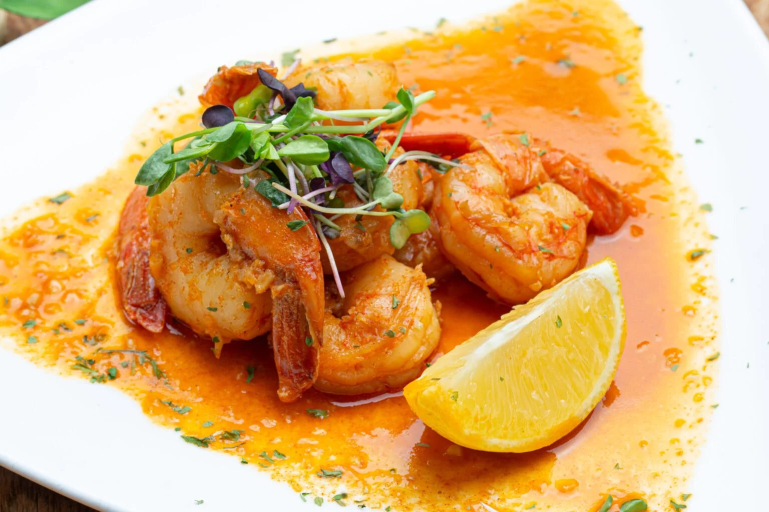 Peppa Shrimp Shell on shrimp tossed with scotch bonnet peppers, fresh herbs, crushed peppercorns, and pimento.