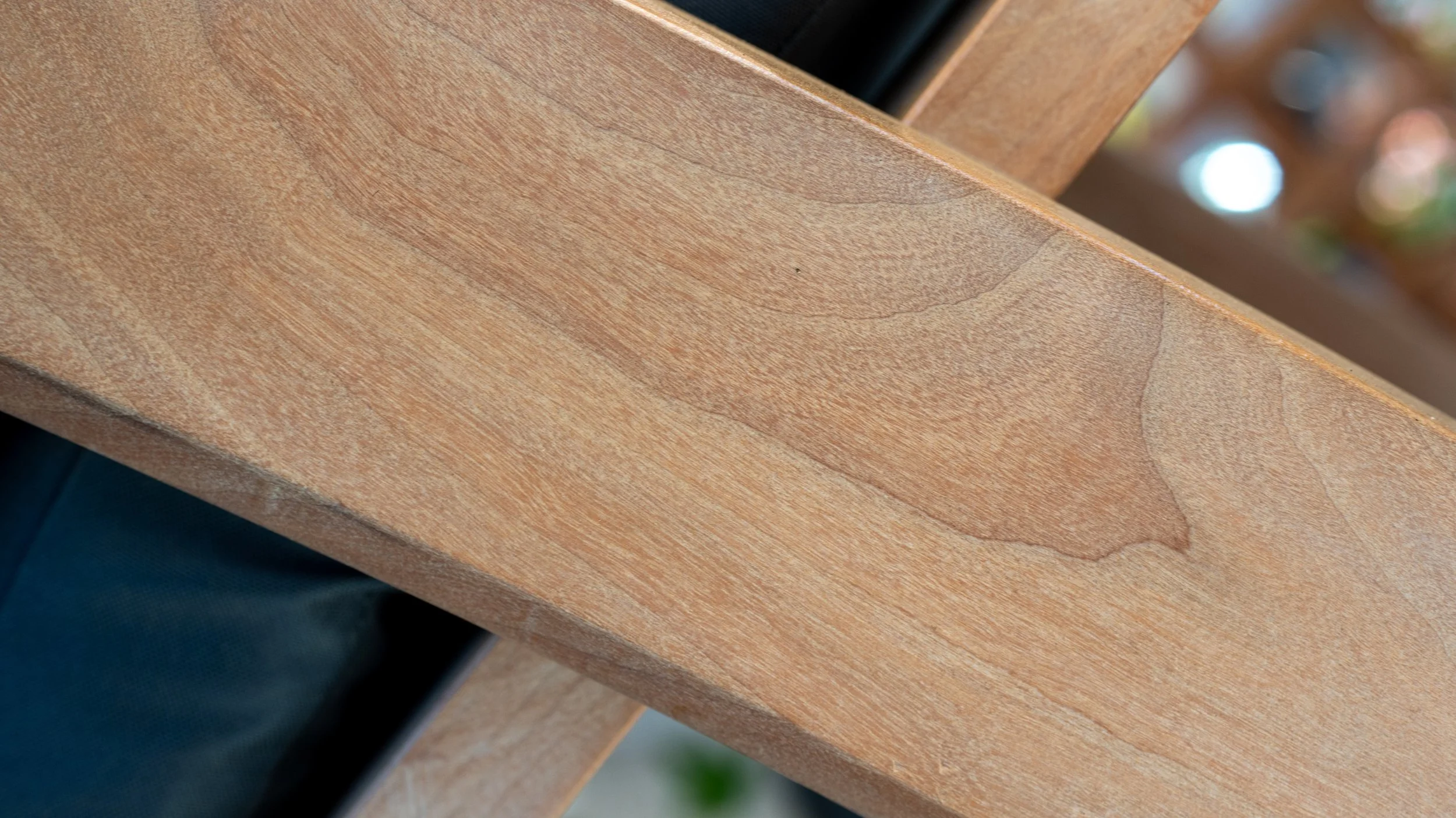 Close-up of a wooden surface with visible grain and a crack.