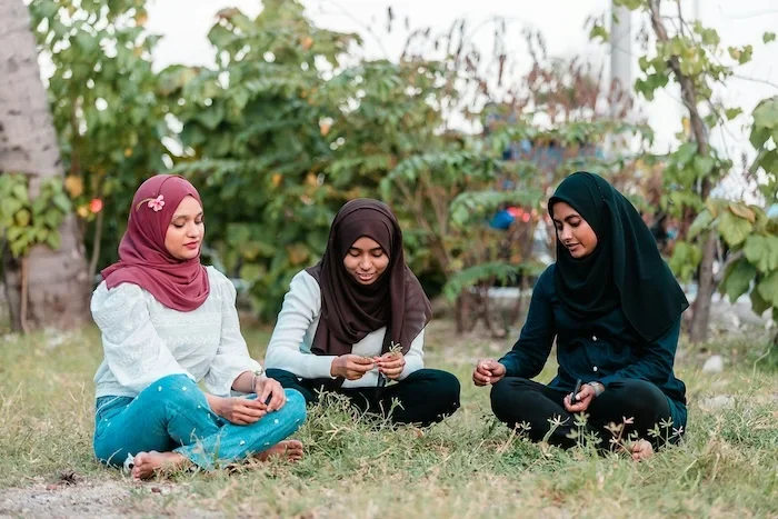A group of three women talking outside.
