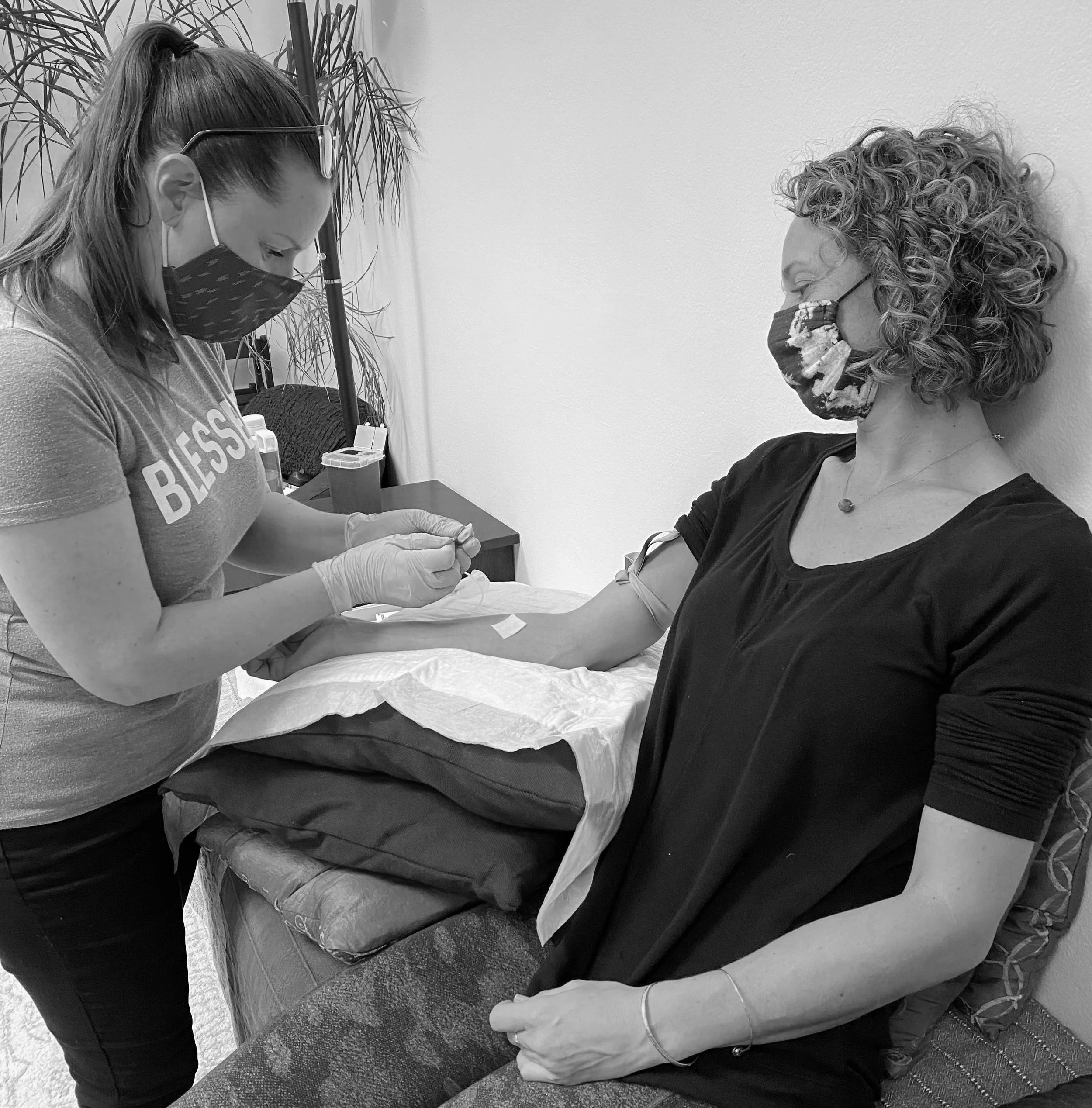 A woman receiving a blood work from a licensed midwife in Los Angeles.