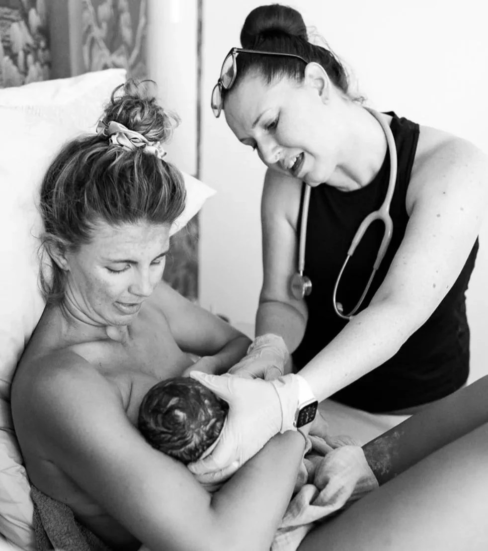 A licensed midwife providing lactation support at a home birth in Los Angeles.