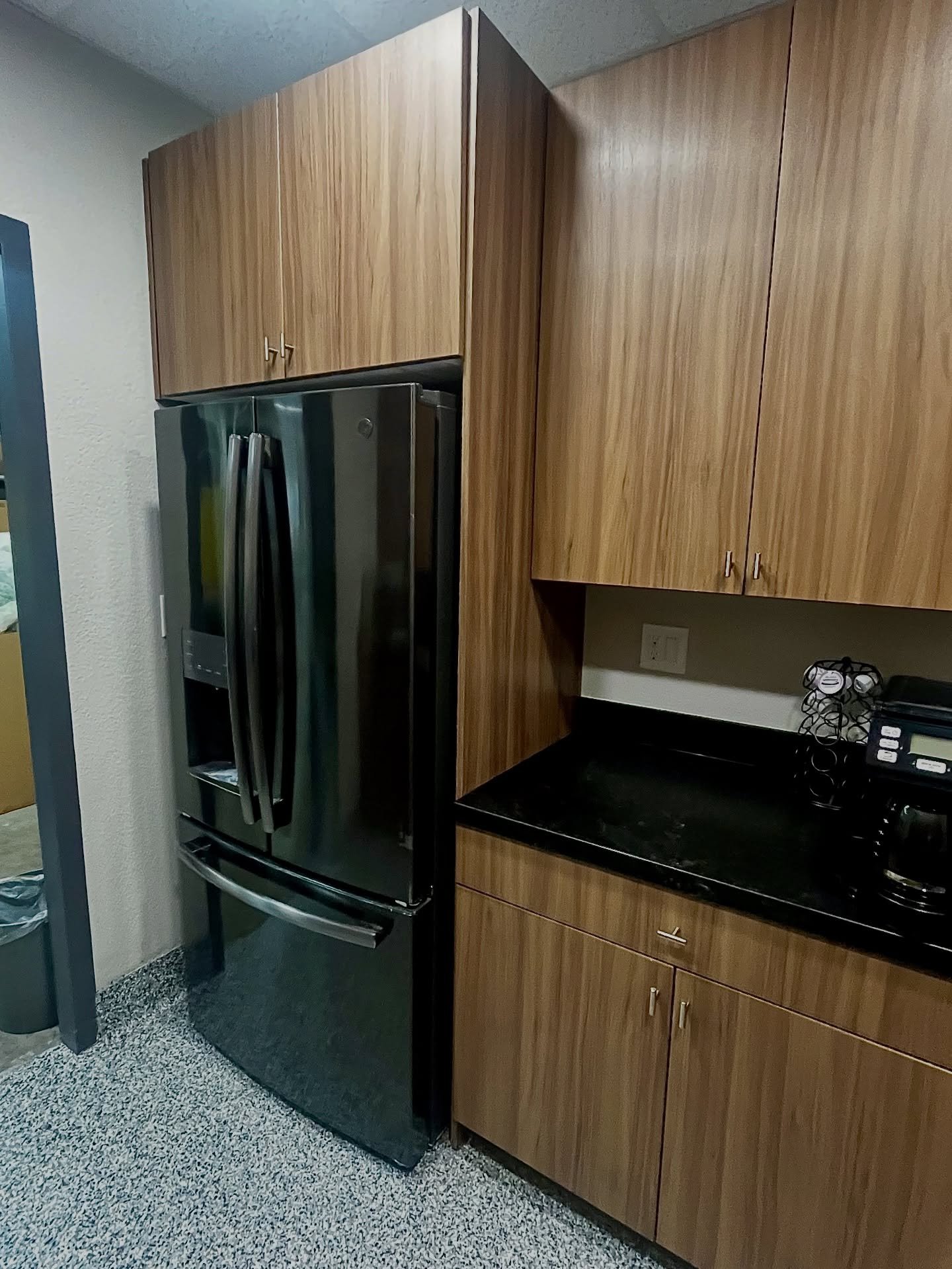Employee Break-Room Refresh!

This old makeshift employee break room needed an upgrade, and these beautiful cabinets did the job! Featuring sleek slab doors in the Lennox Door Style and a warm Canyon Color Thermofoil finish, the space now feels moder