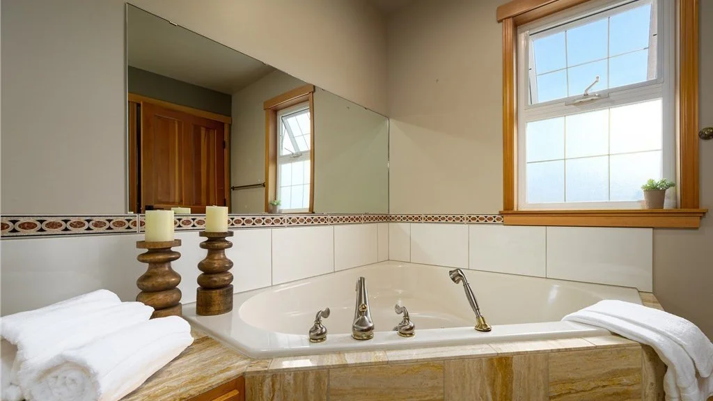 Bathroom jacuzzi tub with mirror and window at 5067 E 26th Dr Bellingham WA 98226