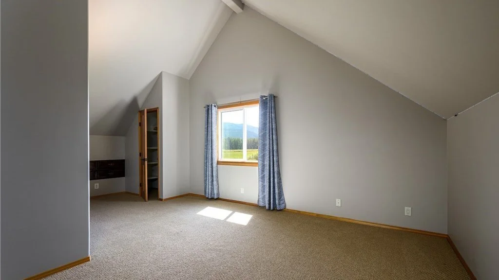Bedroom with slanted ceiling, window and carpeting at 5067 E 26th Dr Bellingham WA 98226