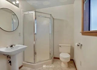 Bathroom with shower stall, window and pedestal sink at 1300 28th Avenue Court, Milton, WA 98354