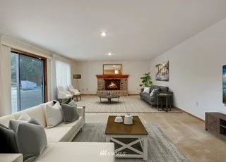 Livingroom with recessed lighting, large windows and fireplace at 1300 28th Avenue Court, Milton, WA 98354
