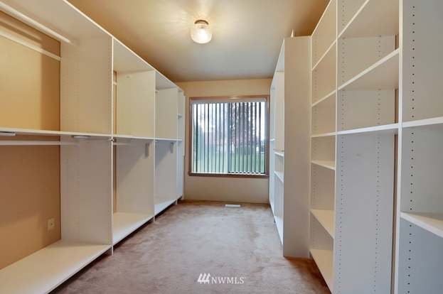 Walk in closed with built in clothing racks and shelving and window at 1300 28th Avenue Court, Milton, WA 98354