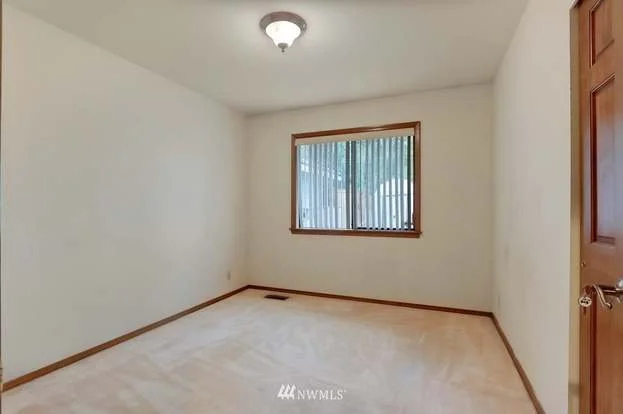Bedroom with low pile carpeting and window at 1300 28th Avenue Court, Milton, WA 98354