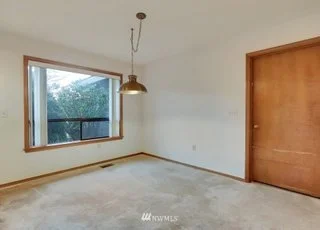 Bedroom with low pile carpeting , large window and closet at 1300 28th Avenue Court, Milton, WA 98354