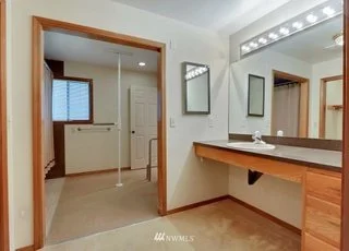 Bathroom with tiled floors and lighted vanity with sink at 1300 28th Avenue Court, Milton, WA 98354
