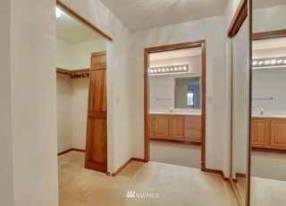 Bedroom with mirrored closets and entrances into bathroom and walk in closet  at 1300 28th Avenue Court, Milton, WA 98354