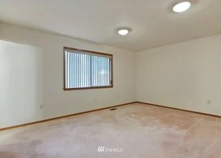 Bedroom with low pile carpeting and window at 1300 28th Avenue Court, Milton, WA 98354