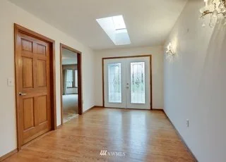 Double door glass paned entrance with hardwood floors and skylight at 1300 28th Avenue Court, Milton, WA 98354