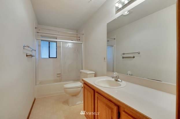 Bathroom with tub/shower combo, small window and long vanity at 1300 28th Avenue Court, Milton, WA 98354