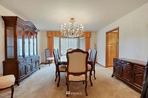 Formal dining room with low pile carpeting, windows and chandelier at 1300 28th Avenue Court, Milton, WA 98354